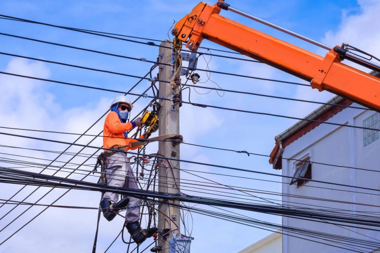 electrician-with-crane-truck-is-installing-electri-EKYNVA3